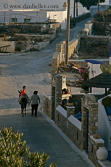 woman-walking-w-boy-on-donnkey.jpg