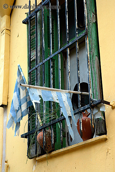 torn-greek-flags-in-window.jpg