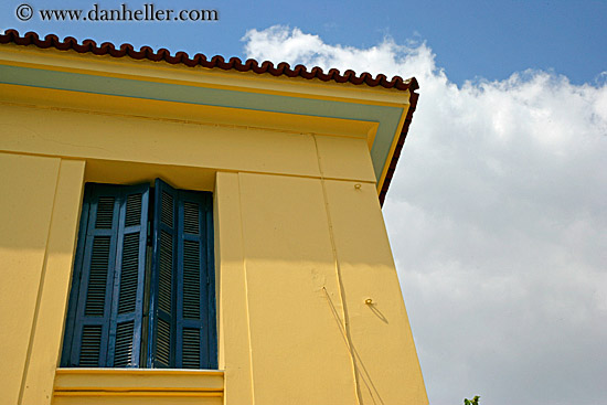 yellow-house-blue-shutters-clouds.jpg
