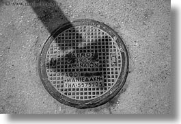 arrows, athens, black and white, covers, europe, greece, horizontal, manholes, shadows, streets, photograph