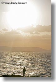 europe, greece, men, naxos, ocean, silhouettes, sun, vertical, photograph