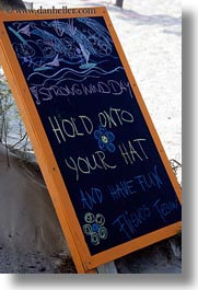 europe, greece, hats, hold, naxos, signs, strong, vertical, wind, photograph