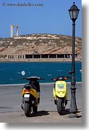 arches, colors, europe, greece, lamp posts, motorcycles, naxos, vehicles, vertical, yellow, photograph