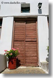 browns, doors, europe, geraniums, greece, old, pink, tinos, vertical, woods, photograph