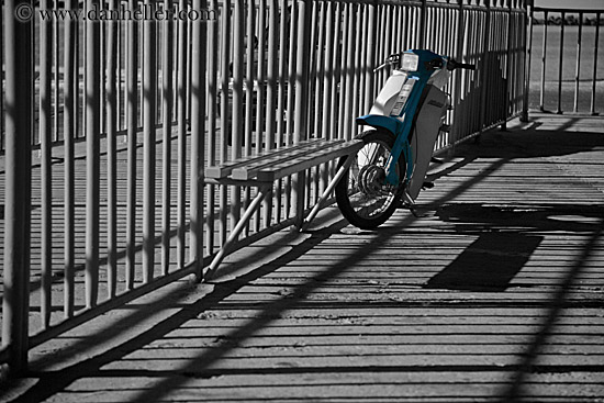 blue-motor-scooter-in-shadowy-bars-bw.jpg