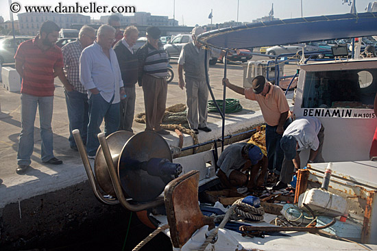 men-watching-men-on-boat.jpg