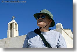 bell towers, clothes, crosses, emotions, europe, greece, hats, horizontal, howard, men, people, senior citizen, serious, sunglasses, tourists, photograph