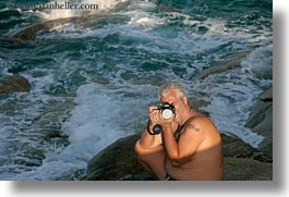 artists, cameras, emotions, europe, greece, horizontal, kostas, men, ocean, people, photographers, photographing, smiles, sun, tourists, photograph