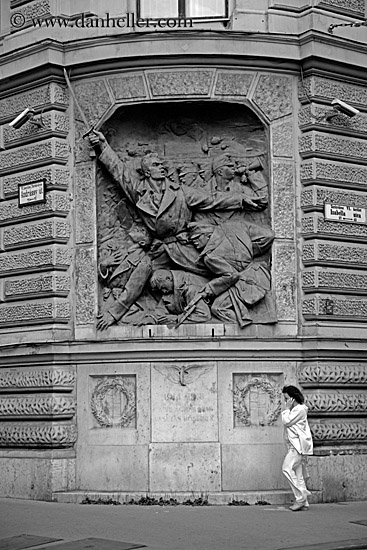 woman-on-cell_phone-walking-by-communist-relief-1-bw.jpg