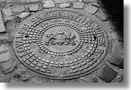 black and white, budapest, cobblestones, covers, europe, horizontal, hungary, irons, manhole covers, manholes, materials, photograph