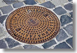 budapest, cobblestones, covers, europe, horizontal, hungary, irons, manhole covers, manholes, materials, photograph