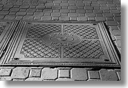 black and white, budapest, cobblestones, covers, europe, horizontal, hungary, irons, manhole covers, manholes, materials, photograph