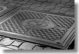 black and white, budapest, cobblestones, covers, europe, horizontal, hungary, irons, manhole covers, manholes, materials, photograph