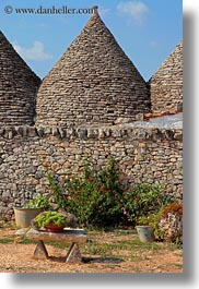 alberobello, buildings, europe, farm house, flowers, italy, puglia, structures, trullis, vertical, photograph