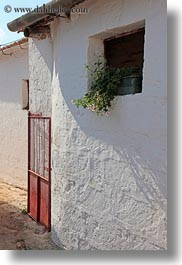 alberobello, buildings, europe, farm house, flowers, gates, italy, puglia, red, vertical, walls, wash, white, photograph