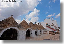 alberobello, buildings, clouds, cumulus, europe, farm house, horizontal, italy, puglia, structures, trullis, photograph