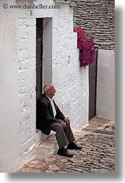 alberobello, doorways, europe, italy, men, people, puglia, sitting, vertical, photograph