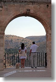 arches, dogs, europe, italy, matera, men, puglia, vertical, womens, photograph