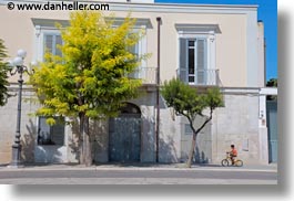 bikes, boys, buildings, europe, green, horizontal, italy, people, puglia, trani, trees, white, photograph