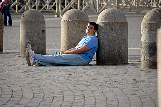 man-sitting-on-cobblestones.jpg