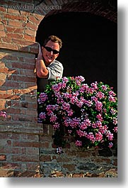bricks, europe, flowers, italy, men, sunglasses, tuscany, vertical, photograph