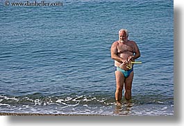 beaches, europe, fat, horizontal, isola giglio, italy, men, ocean, towns, tuscany, wading, water, photograph