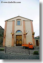 bricks, churches, cobblestones, doors, europe, italy, montalcino, oranges, streets, towns, trucks, tuscany, vertical, photograph