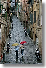 cobblestones, couples, europe, italy, people, siena, towns, tuscany, umbrellas, vertical, walking, photograph