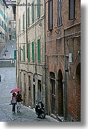 cobblestones, couples, europe, italy, people, siena, towns, tuscany, umbrellas, vertical, walking, photograph