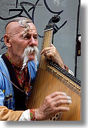 artists, europe, harp, krakow, men, musicians, odd, people, playing, poland, vertical, photograph
