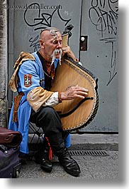 artists, europe, harp, krakow, men, musicians, odd, people, playing, poland, vertical, photograph