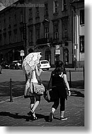 black and white, europe, krakow, parasol, people, poland, vertical, white, womens, photograph