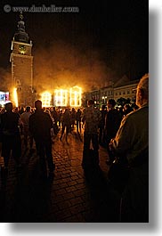bell towers, buildings, clock tower, crowds, europe, fire, krakow, nite, people, performance, poland, smoke, structures, vertical, photograph