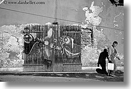 black and white, doors, europe, graffiti, horizontal, men, ptuj, slovenia, walking, photograph