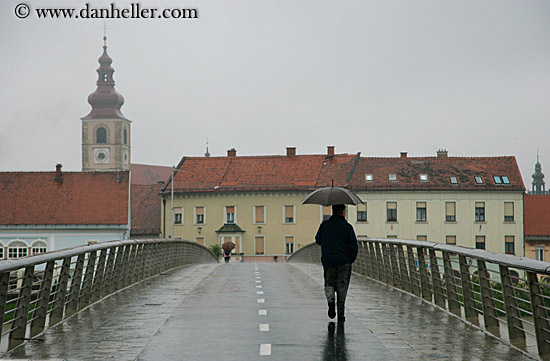 man-walking-bridge-in-rain.jpg