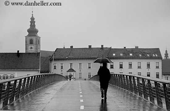 man-walking-bridge-in-rain-bw.jpg