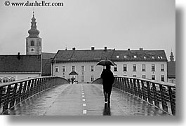 black and white, bridge, europe, horizontal, men, ptuj, rain, slovenia, walking, photograph