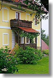 europe, greenery, houses, slovenia, styria, vertical, yellow, photograph