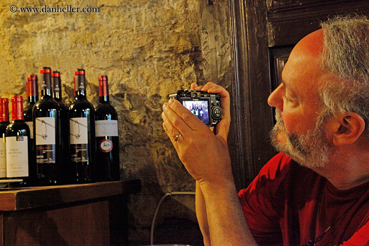 man-photographing-wine-bottles.jpg