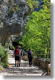 activities, europe, forests, hikers, hiking, nature, ordesa, overhang, people, plants, rocks, spain, trees, under, vertical, photograph