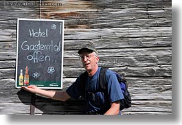 barn, chalkboard, emotions, europe, gasterntal valley, hikers, horizontal, kandersteg, men, people, senior citizen, smiles, switzerland, photograph