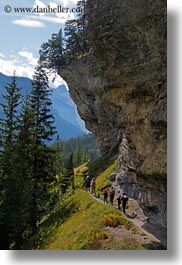 cliffs, clouds, europe, hikers, hiking, kandersteg, lake oeschinensee, nature, people, sky, switzerland, under, vertical, photograph