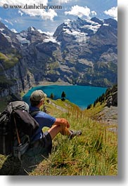 clouds, europe, hikers, kandersteg, lake oeschinensee, lakes, men, mountains, nature, oeschinensee, people, sky, snowcaps, switzerland, vertical, photograph