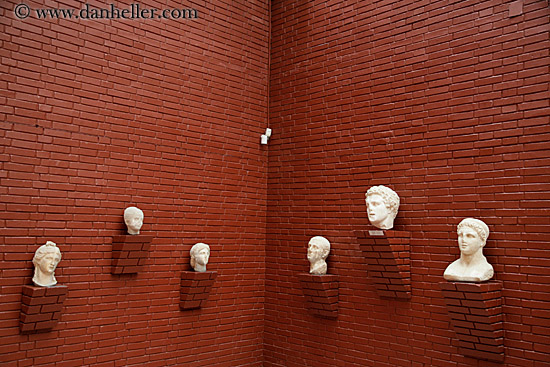 stone-statue-heads-on-wall-2.jpg