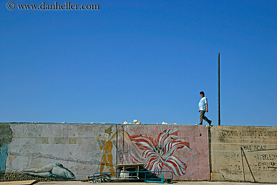 man-walking-atop-mural.jpg