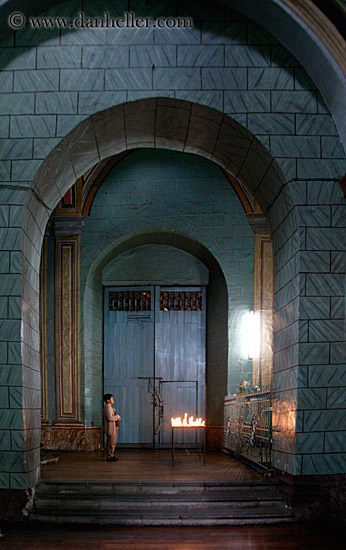 woman-praying-at-candles-2.jpg