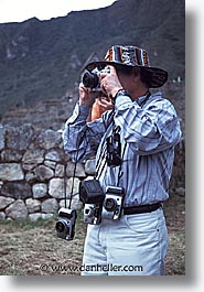 ancient ruins, andes, architectural ruins, cameras, inca trail, incan tribes, latin america, marco, mountains, people, peru, stone ruins, vertical, photograph