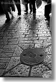 black and white, covers, israel, jerusalem, manholes, middle east, vertical, walkers, photograph
